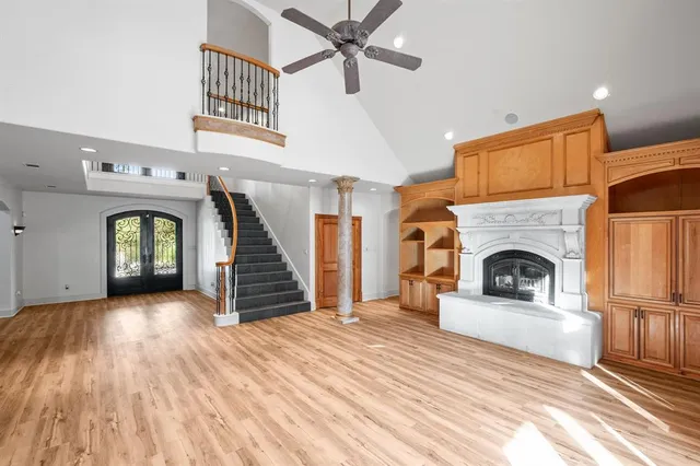a view of a livingroom with a fireplace a ceiling fan and a rug