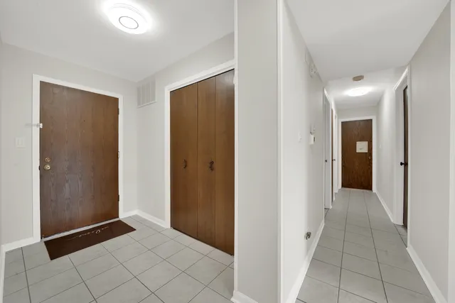 a view of a hallway to rooms