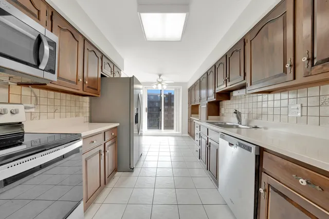 a kitchen with stainless steel appliances granite countertop a sink and cabinets