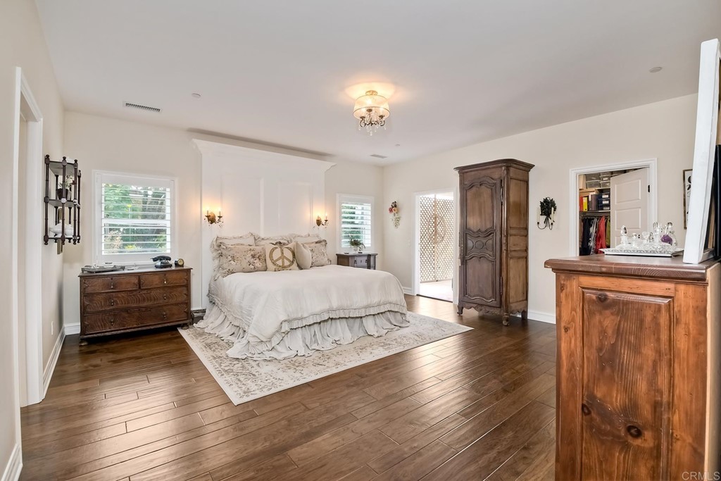 1494 Meredith Road Fallbrook, CA 92028 - Photo 17 of 47 a spacious bedroom with a bed and a dresser