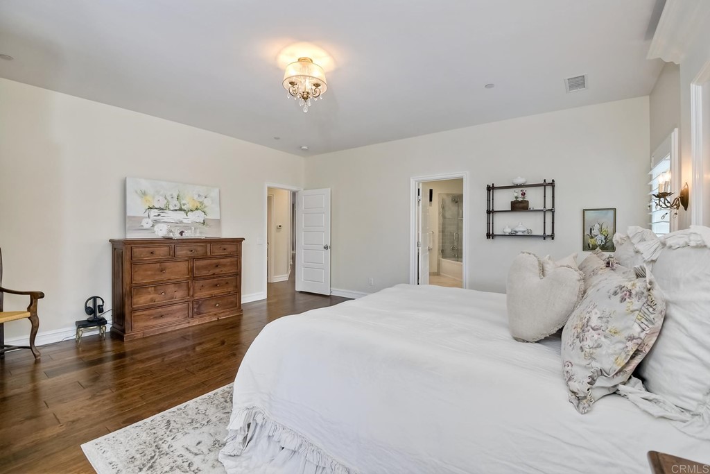 1494 Meredith Road Fallbrook, CA 92028 - Photo 18 of 47 a bedroom with a bed and wooden floor