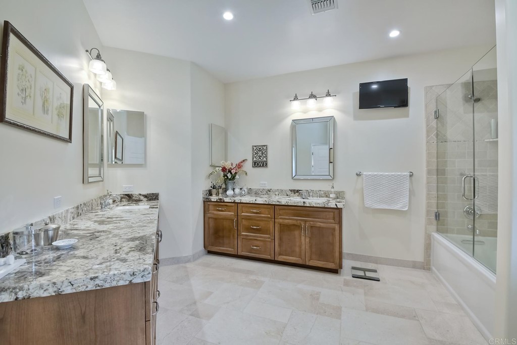 1494 Meredith Road Fallbrook, CA 92028 - Photo 20 of 47 a bathroom with a granite countertop sink a mirror and a bathtub