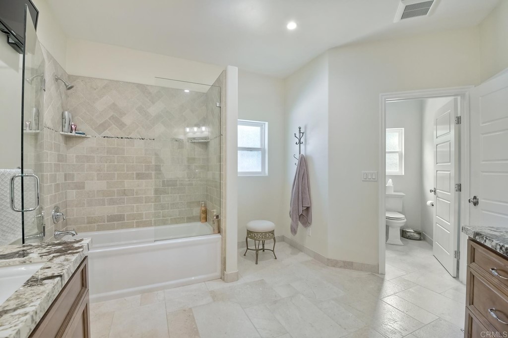 1494 Meredith Road Fallbrook, CA 92028 - Photo 21 of 47 a spacious bathroom with a granite countertop tub mirror and a shower