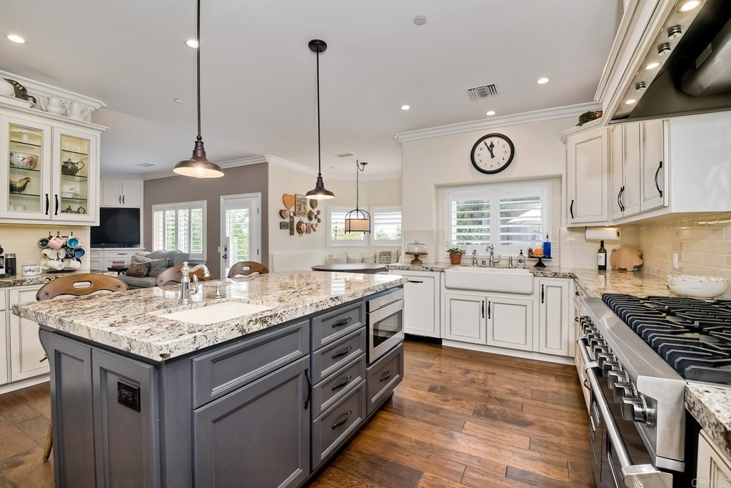 1494 Meredith Road Fallbrook, CA 92028 - Photo 24 of 47 a kitchen with a sink stove and cabinets
