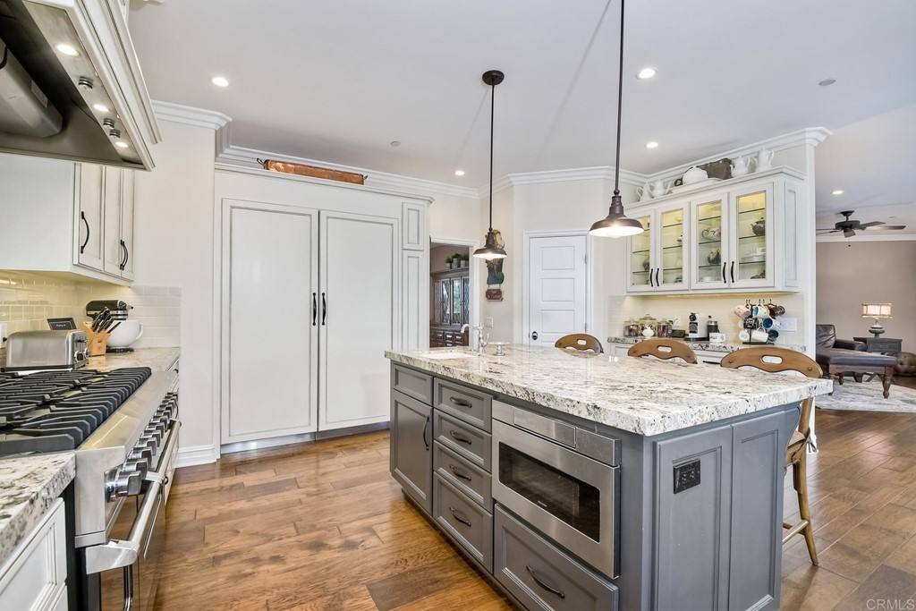1494 Meredith Road Fallbrook, CA 92028 - Photo 25 of 47 a kitchen with a stove and a sink