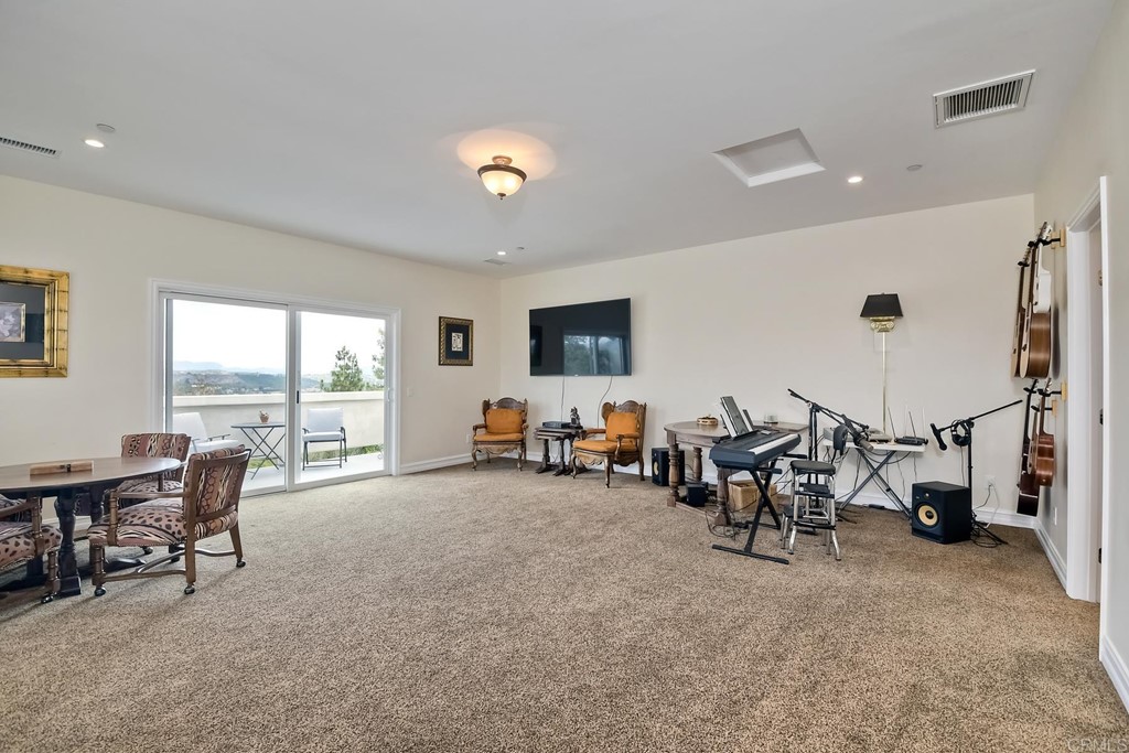 1494 Meredith Road Fallbrook, CA 92028 - Photo 34 of 47 a living room with furniture and large windows