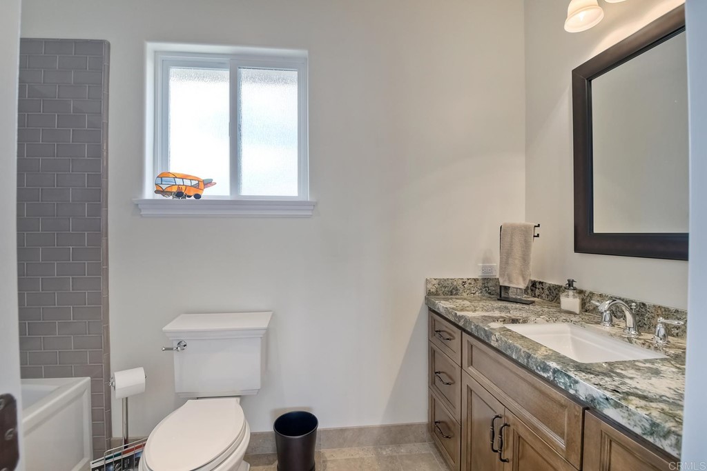 1494 Meredith Road Fallbrook, CA 92028 - Photo 36 of 47 a bathroom with a granite countertop toilet sink and mirror