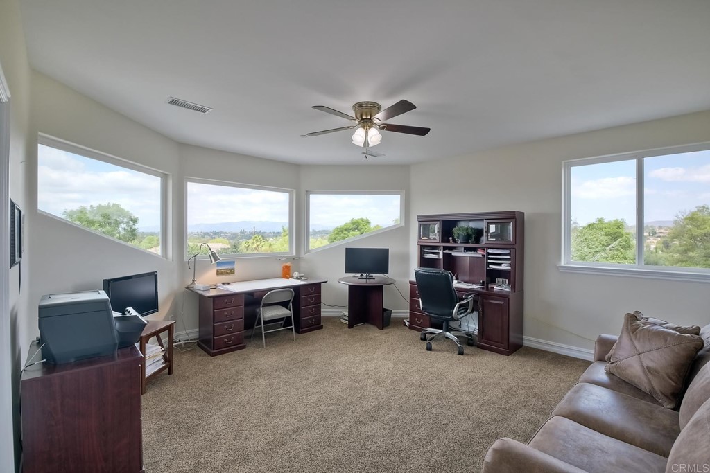 1494 Meredith Road Fallbrook, CA 92028 - Photo 37 of 47 a living room with furniture a window and a flat screen tv