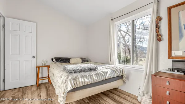 a bedroom with furniture and a flat screen tv