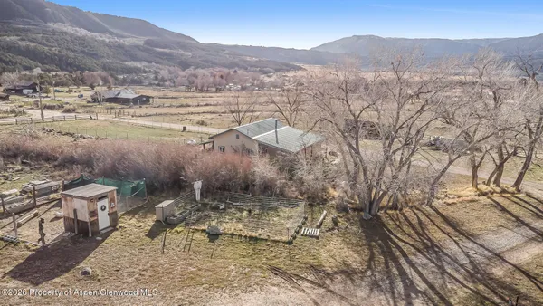 a view of a house with a yard and covered with snow