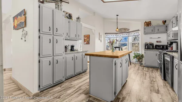 a kitchen with a sink stove and cabinets
