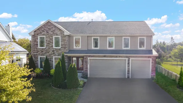 a front view of a house with a garden