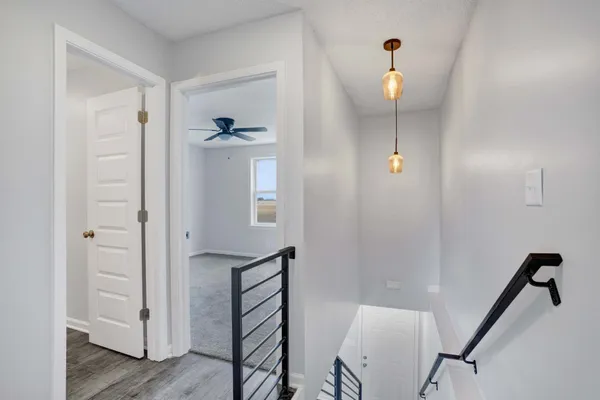 a view of a hallway with wooden floor and entryway