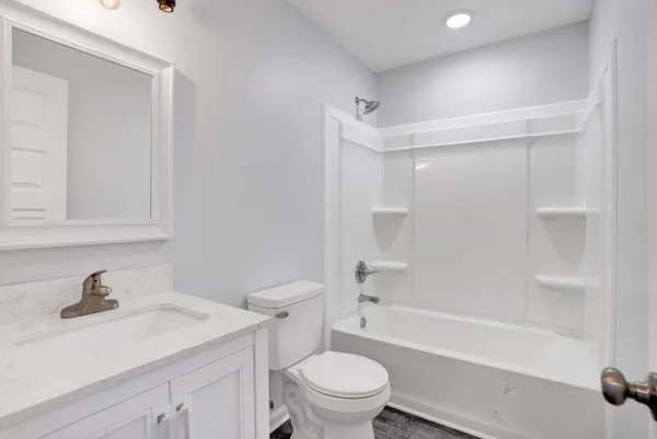 a bathroom with a sink a toilet and a bathtub