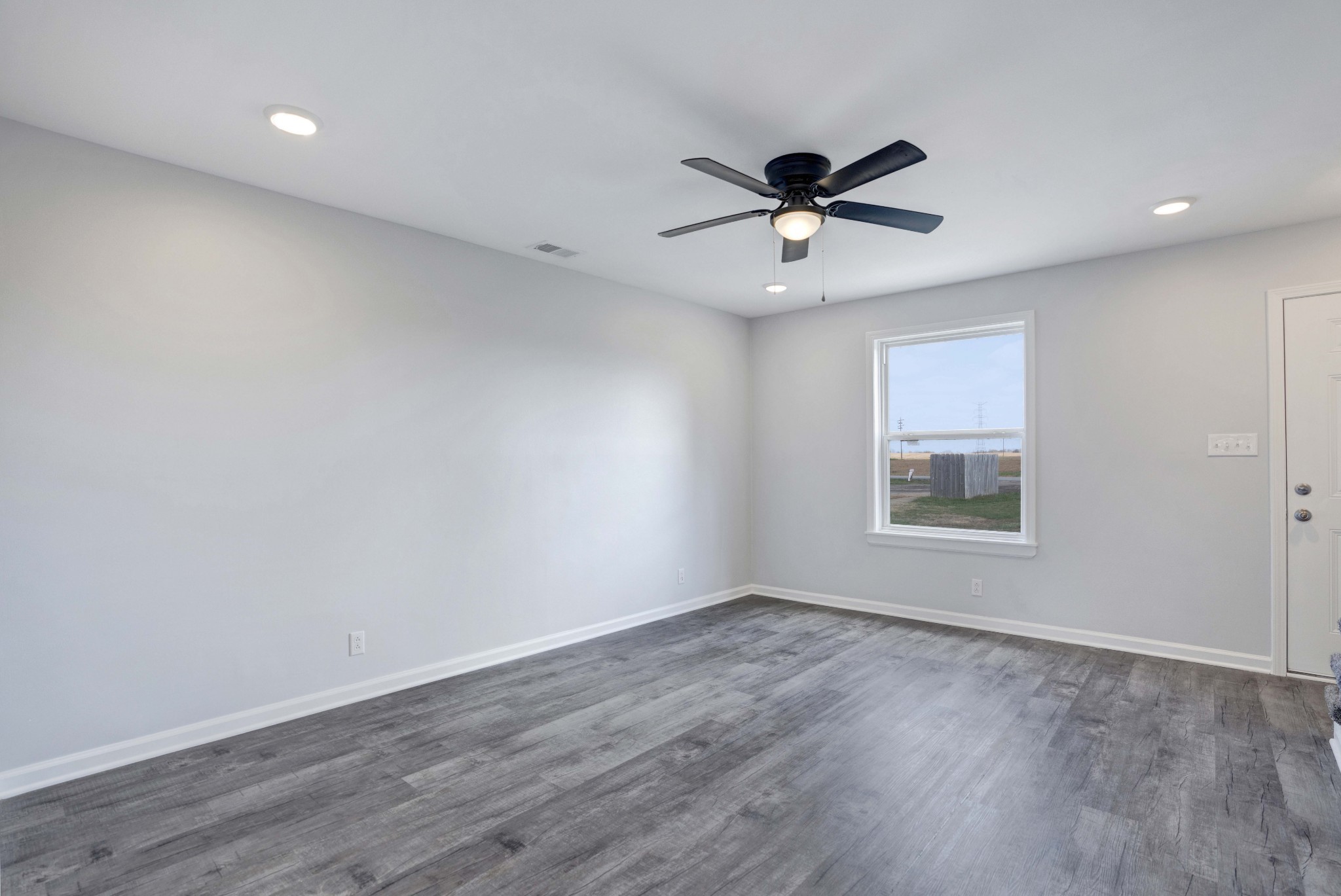 1108 Pembroke Oak Grove Road, Unit 19 Oak Grove, KY 42262 - Photo 6 of 18 a view of a big room with wooden floor a ceiling fan and windows