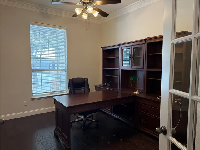 a view of an empty room with wooden floor and a cabinet