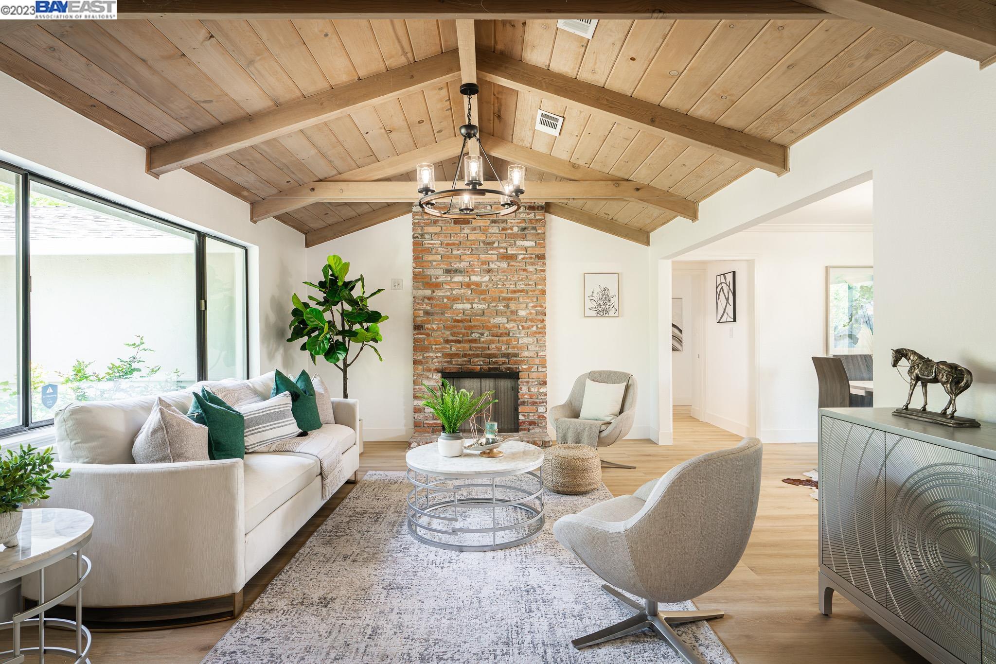 a living room with fireplace furniture and a chandelier