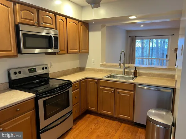 a kitchen with a sink stove and microwave