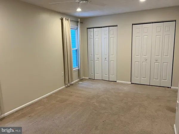 an empty room with closet area