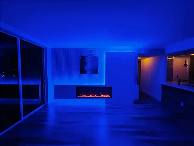 a view of a kitchen with wooden floor and outdoor space