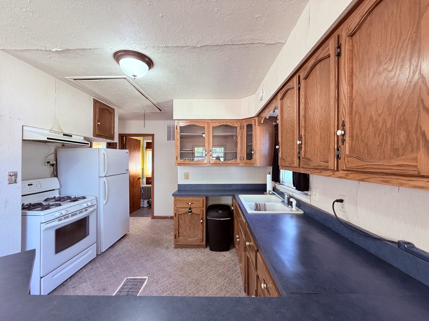 120 West Cherry Street Clinton, IL 61727 - Photo 8 of 15 a kitchen with stainless steel appliances granite countertop a stove and a refrigerator