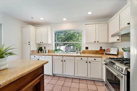 a kitchen with a sink stove and cabinets