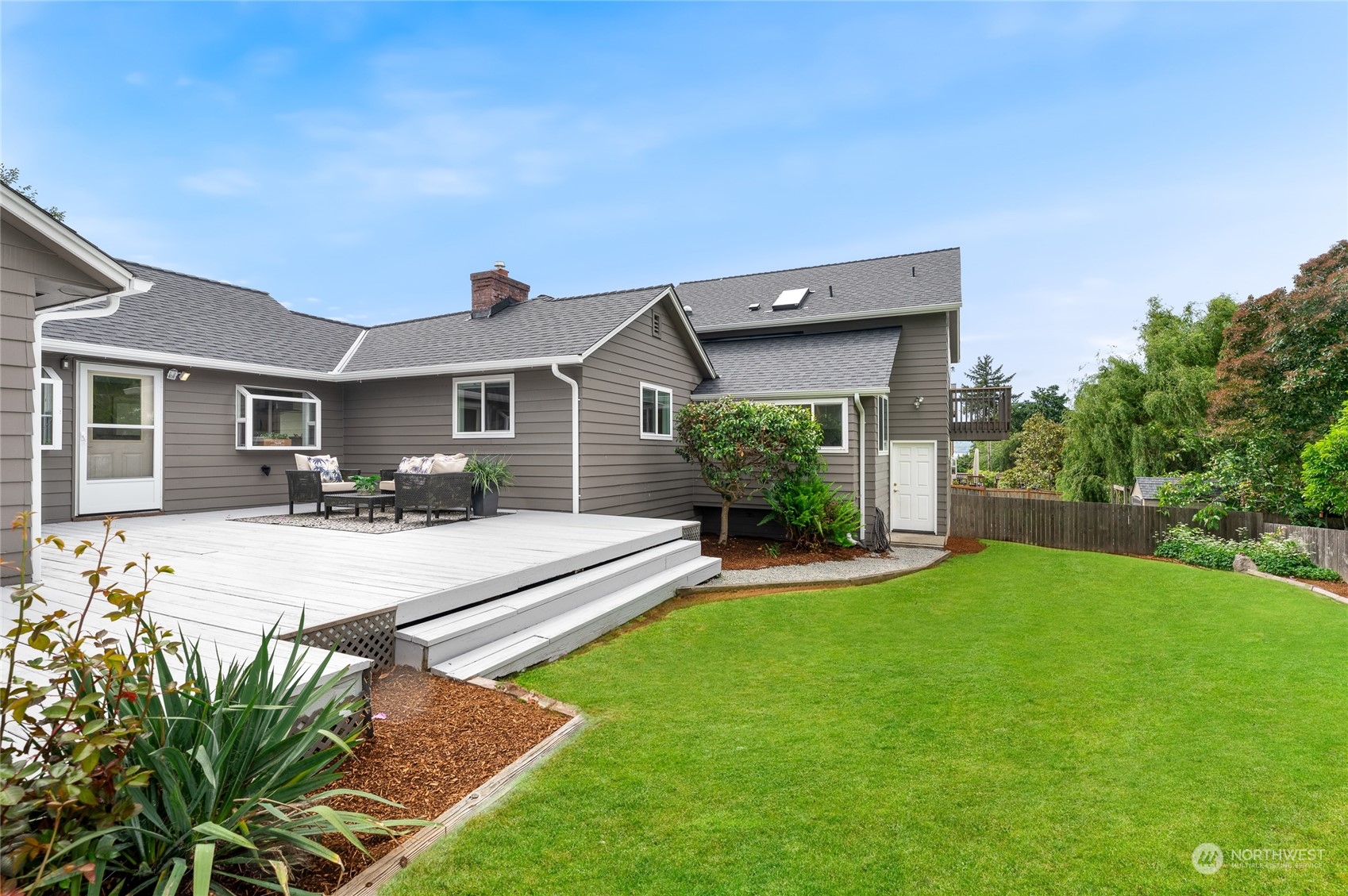 914 North 33rd Street Renton, WA 98056 - Photo 13 of 37 a view of a house with a yard and table and chairs under an umbrella