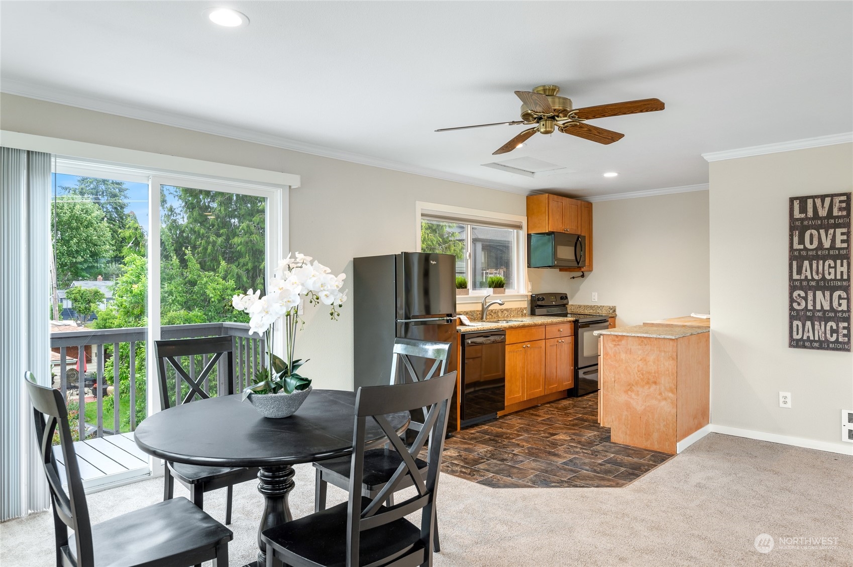 914 North 33rd Street Renton, WA 98056 - Photo 25 of 37 a kitchen with a table chairs refrigerator and microwave