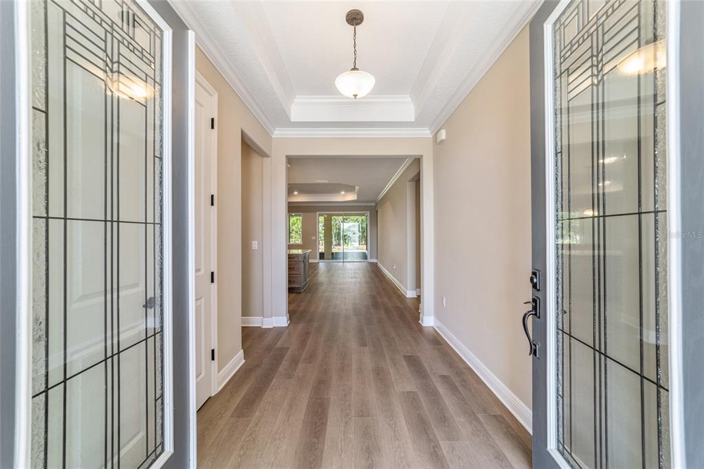 10537 Southwest 96th Lane Road Ocala, FL 34481 - Photo 21 of 75 a view of a hallway with wooden floor and staircase