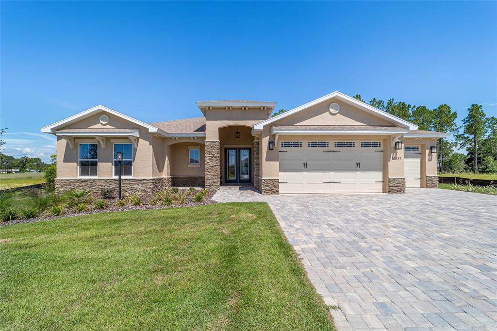 10537 Southwest 96th Lane Road Ocala, FL 34481 - Photo 3 of 75 a front view of a house with a yard