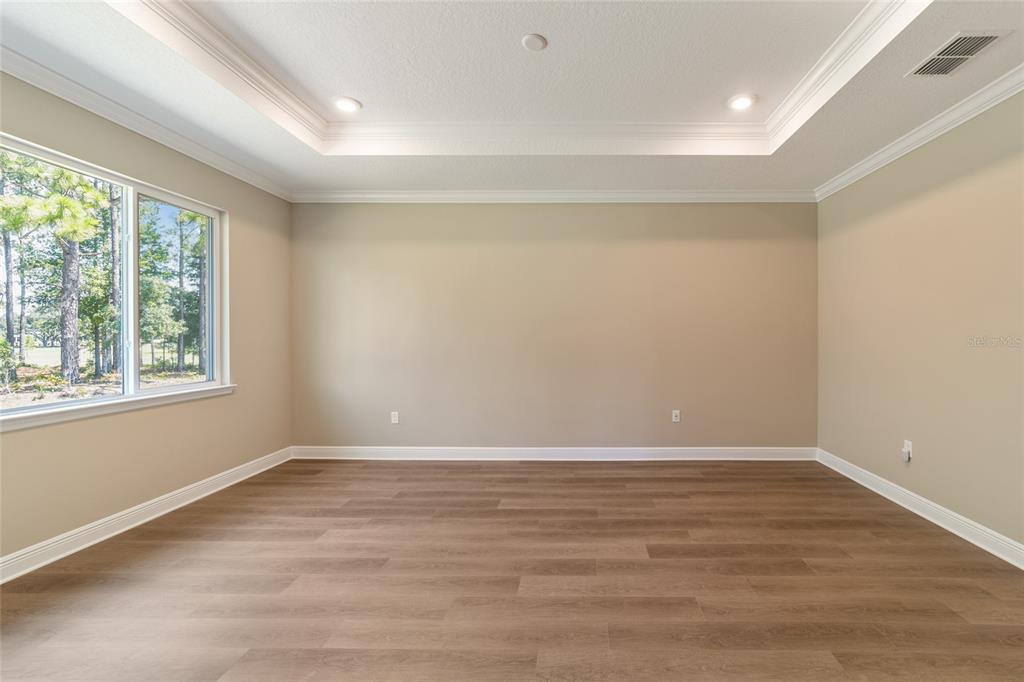 10537 Southwest 96th Lane Road Ocala, FL 34481 - Photo 43 of 75 wooden floor in an empty room with a window