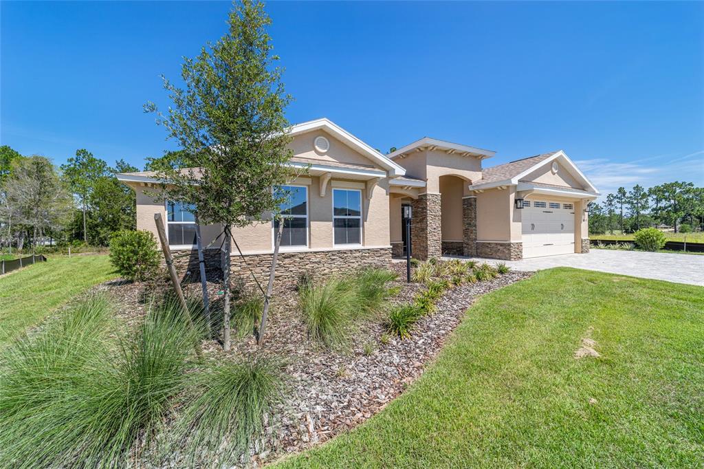 10537 Southwest 96th Lane Road Ocala, FL 34481 - Photo 5 of 75 a front view of a house with a yard