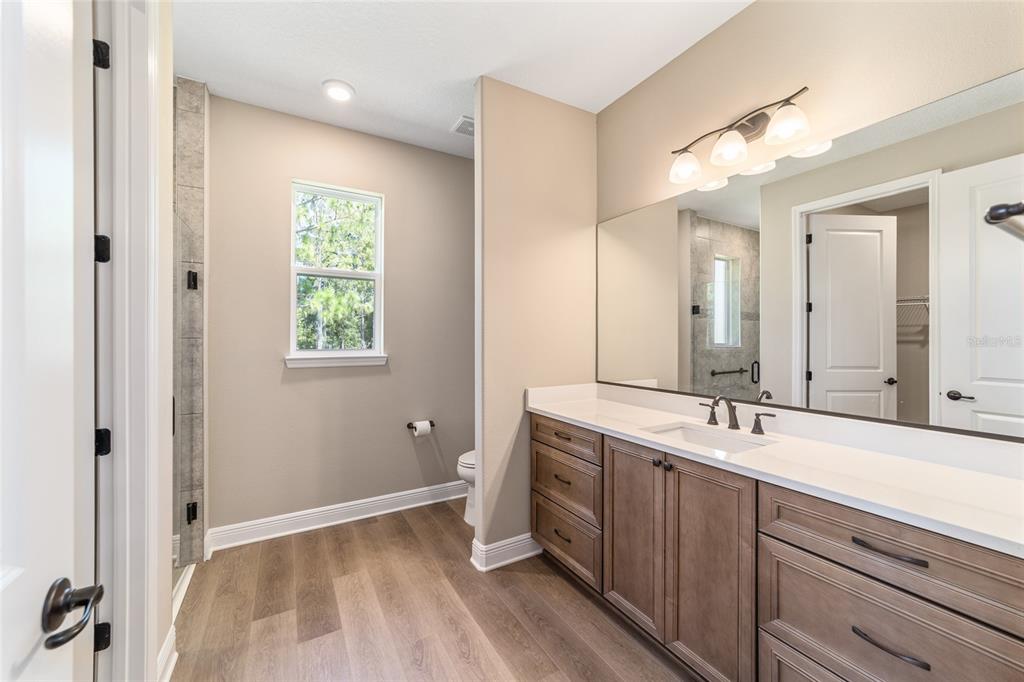 10537 Southwest 96th Lane Road Ocala, FL 34481 - Photo 54 of 75 a spacious bathroom with a double vanity sink and a mirror