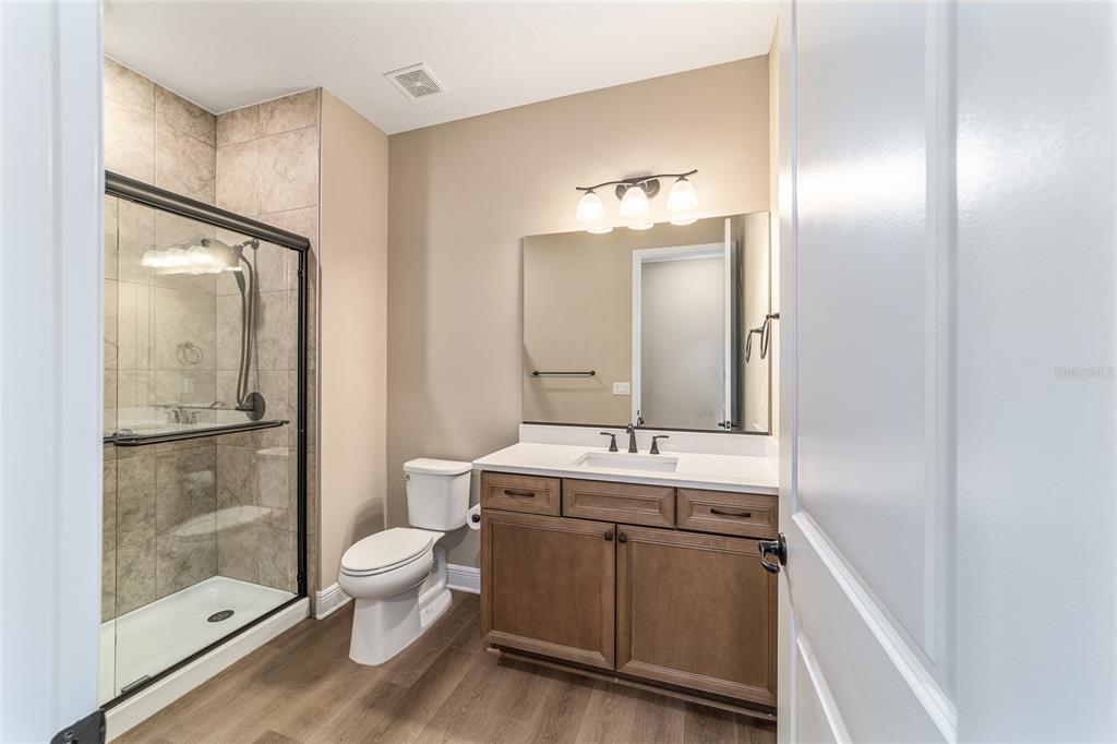 10537 Southwest 96th Lane Road Ocala, FL 34481 - Photo 58 of 75 a bathroom with a double vanity sink toilet mirror and shower
