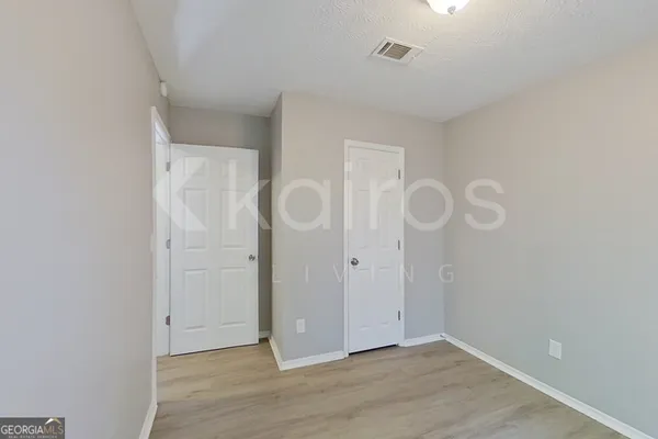 a view of an empty room with wooden floor