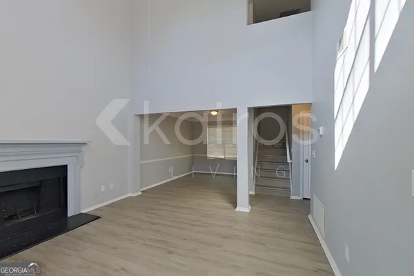 a view of an empty room with a fireplace