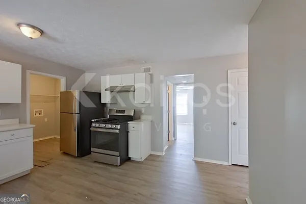 a kitchen with cabinets and stainless steel appliances