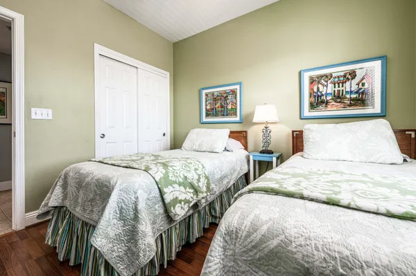 a bedroom with double bed and a painting on the wall