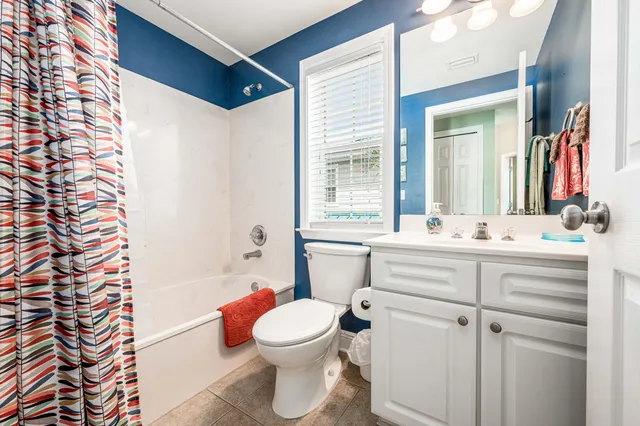 a bathroom with a sink mirror vanity and toilet