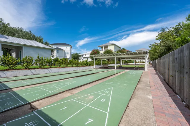 a view of a big house with a big yard and potted plants