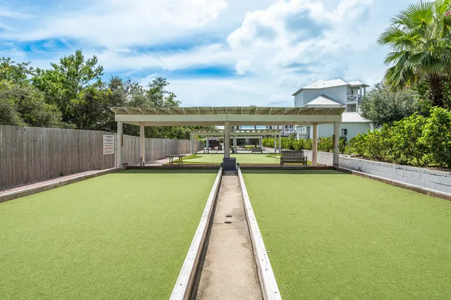 a view of house with swimming pool and seating