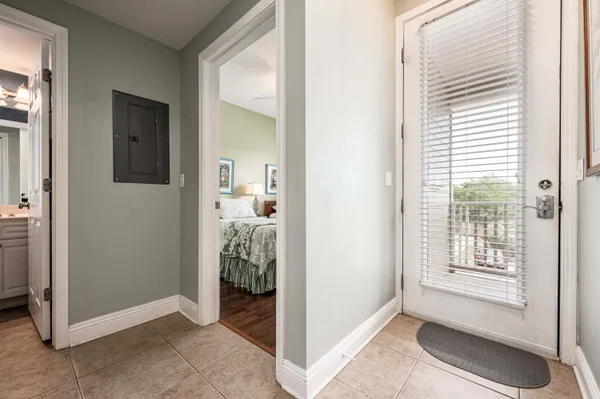 a view of a livingroom with bathroom and front door