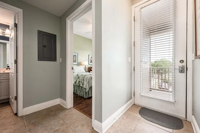 a view of a livingroom with bathroom and front door