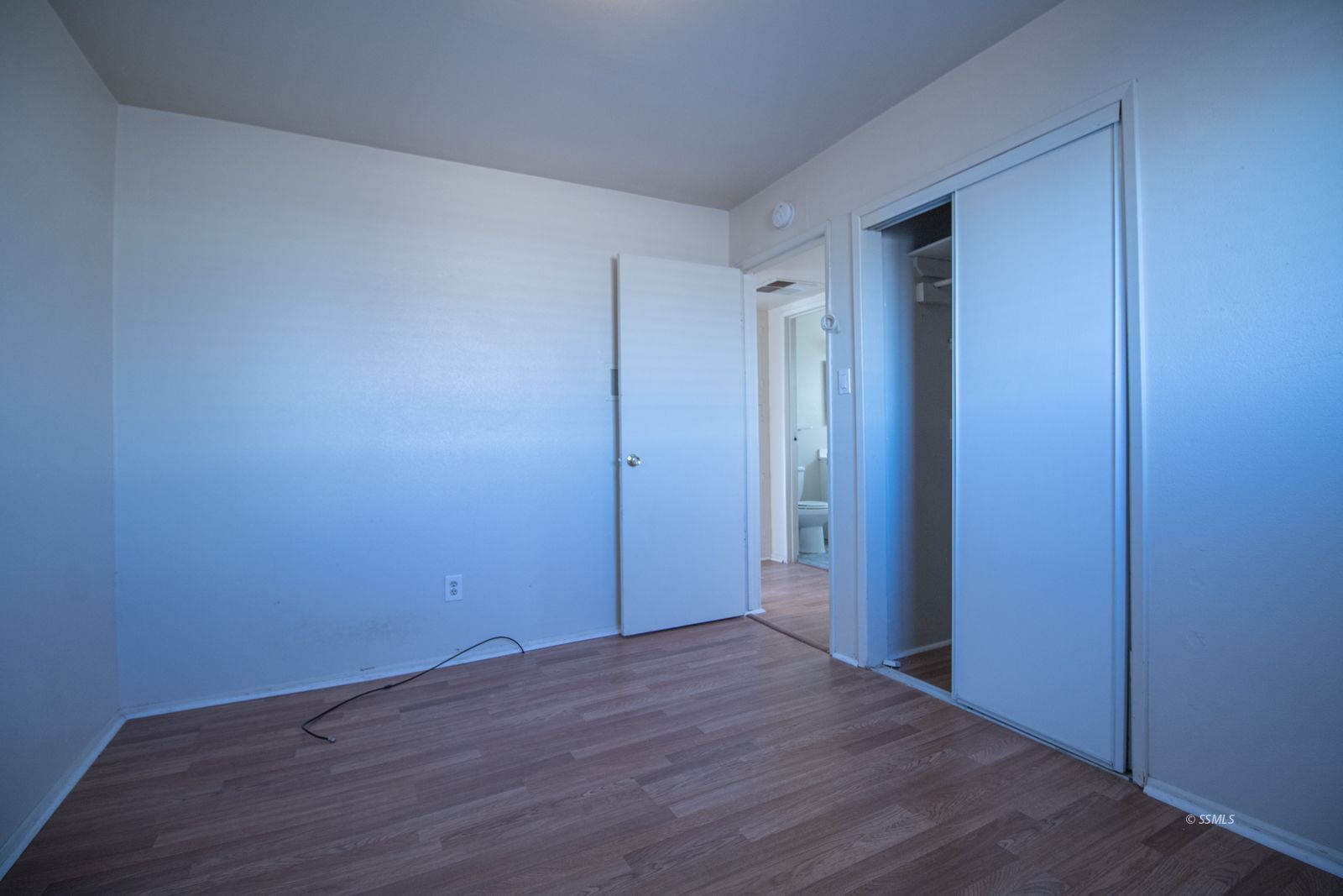 1621 Sims Street Ridgecrest, CA 93555 - Photo 13 of 24 a view of an empty room with wooden floor