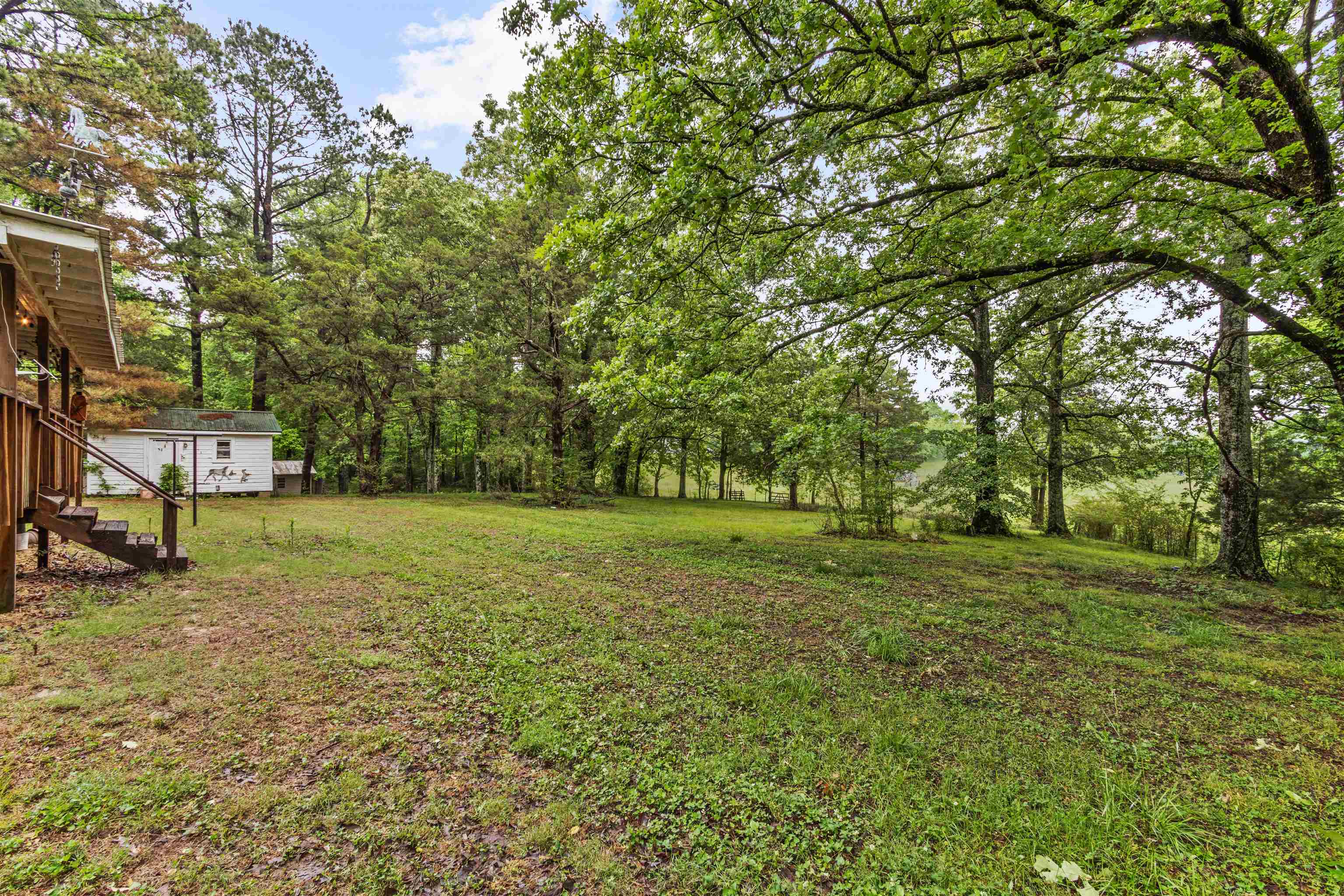 1147 North Collierville Arlington Road Collierville, TN 38017 - Photo 8 of 17 Expansive outdoor space featuring a sloped lawn and mature trees
