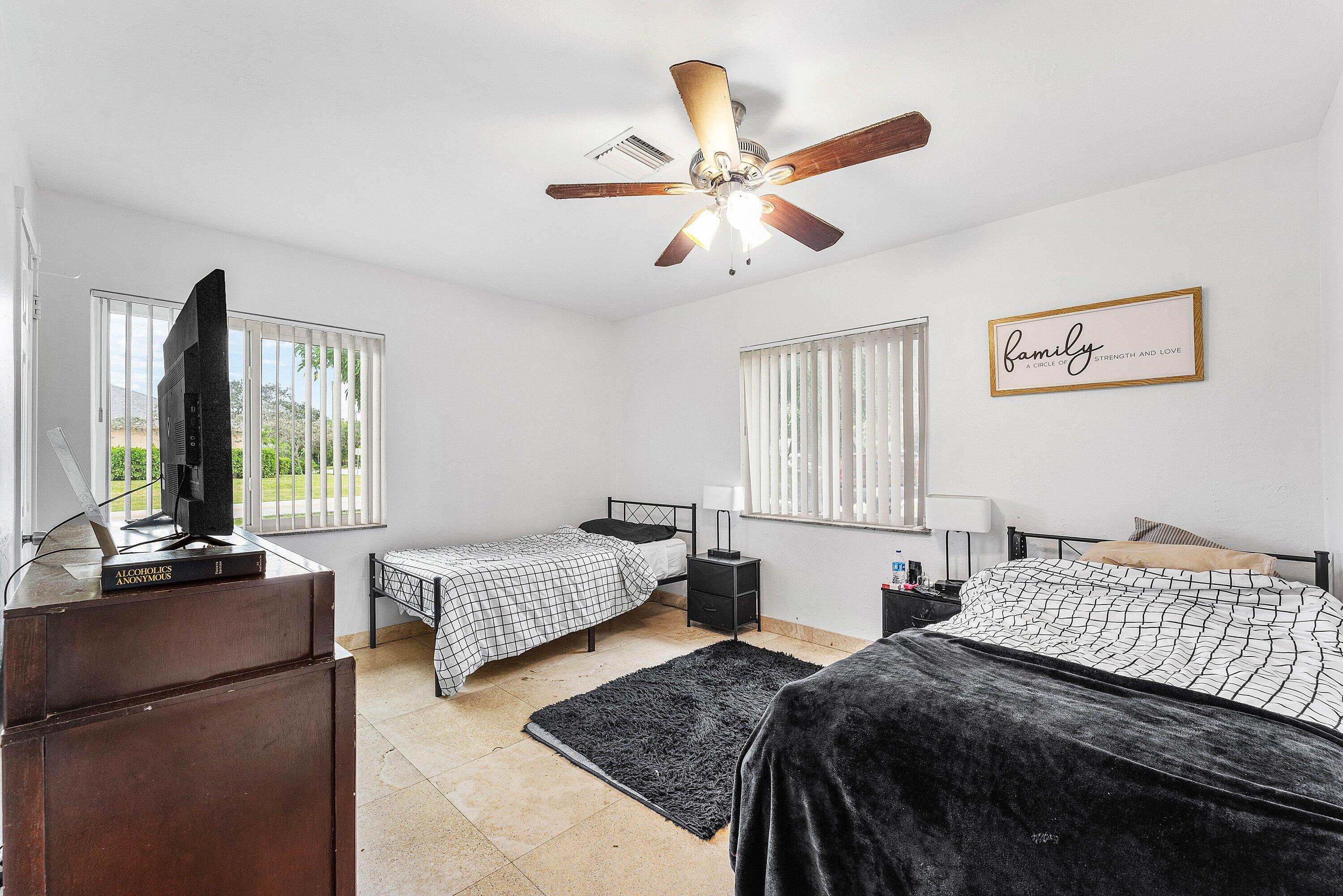 305 Southwest 3rd Street Boynton Beach, FL 33435 - Photo 15 of 36 a bedroom with a bed a window and a couch