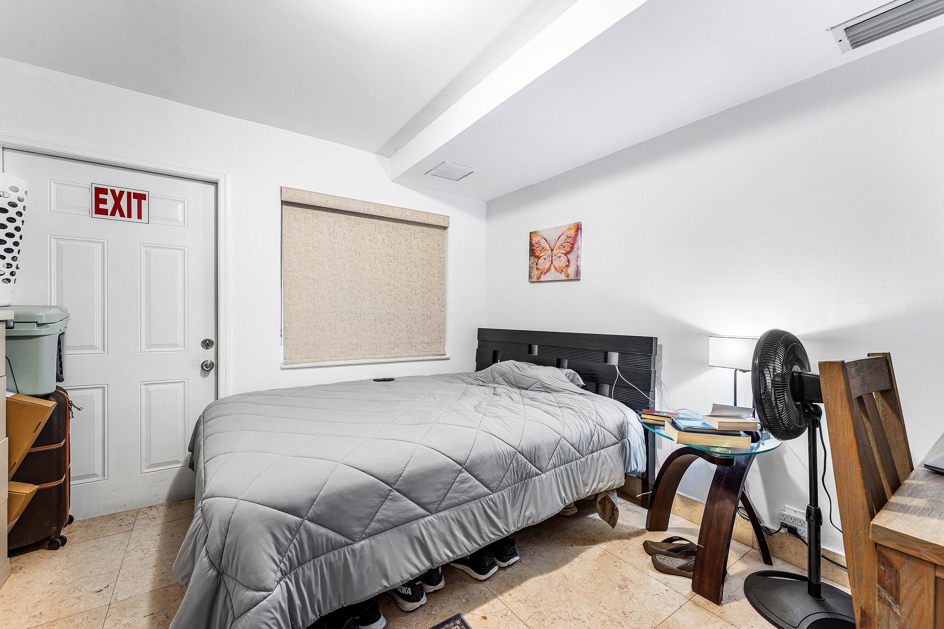 305 Southwest 3rd Street Boynton Beach, FL 33435 - Photo 23 of 36 a bedroom with a bed and a desk