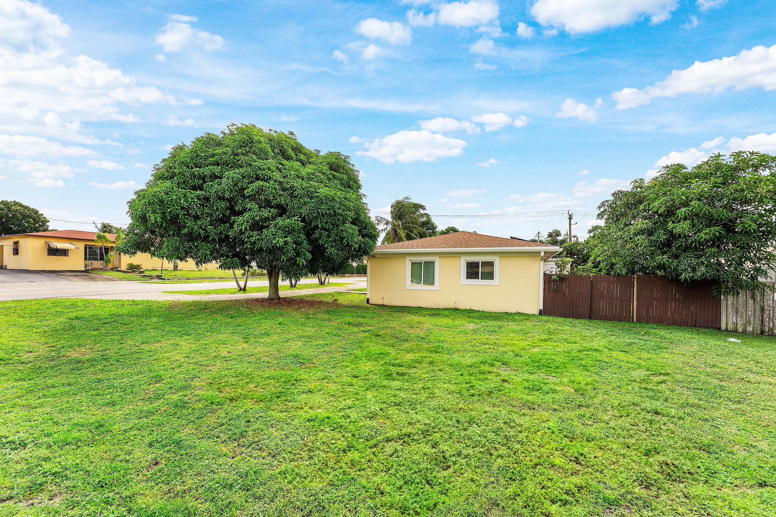 305 Southwest 3rd Street Boynton Beach, FL 33435 - Photo 8 of 36 a view of a house with a yard