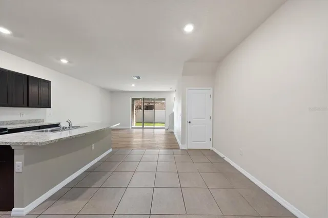 a view of a kitchen with a sink and a refrigerator