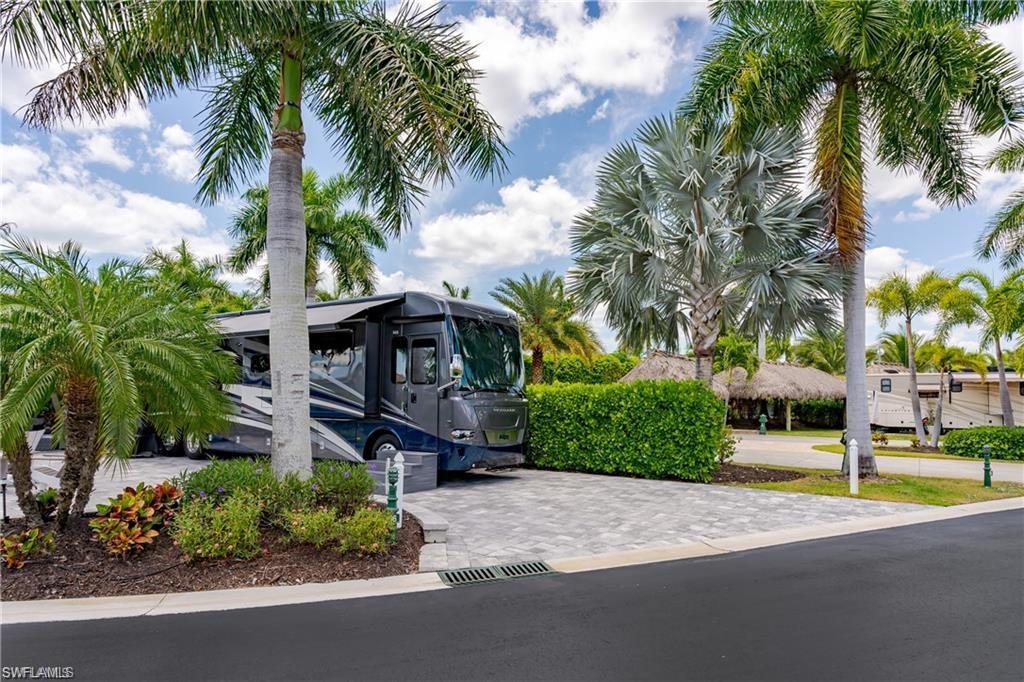 13526 Snook Circle Naples, FL 34114 - Photo 18 of 36 a front view of a house with a garden and a yard